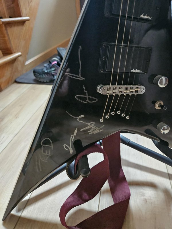 Removing marker from a guitar.   My husband was gi..